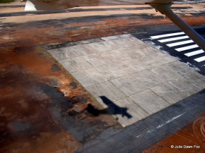 Shadow of a tiny plane on a runway